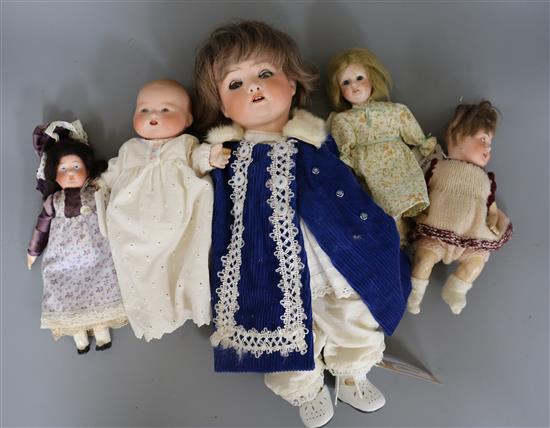 A Heubach Koppelsdorf doll and four other smaller bisque head dolls,